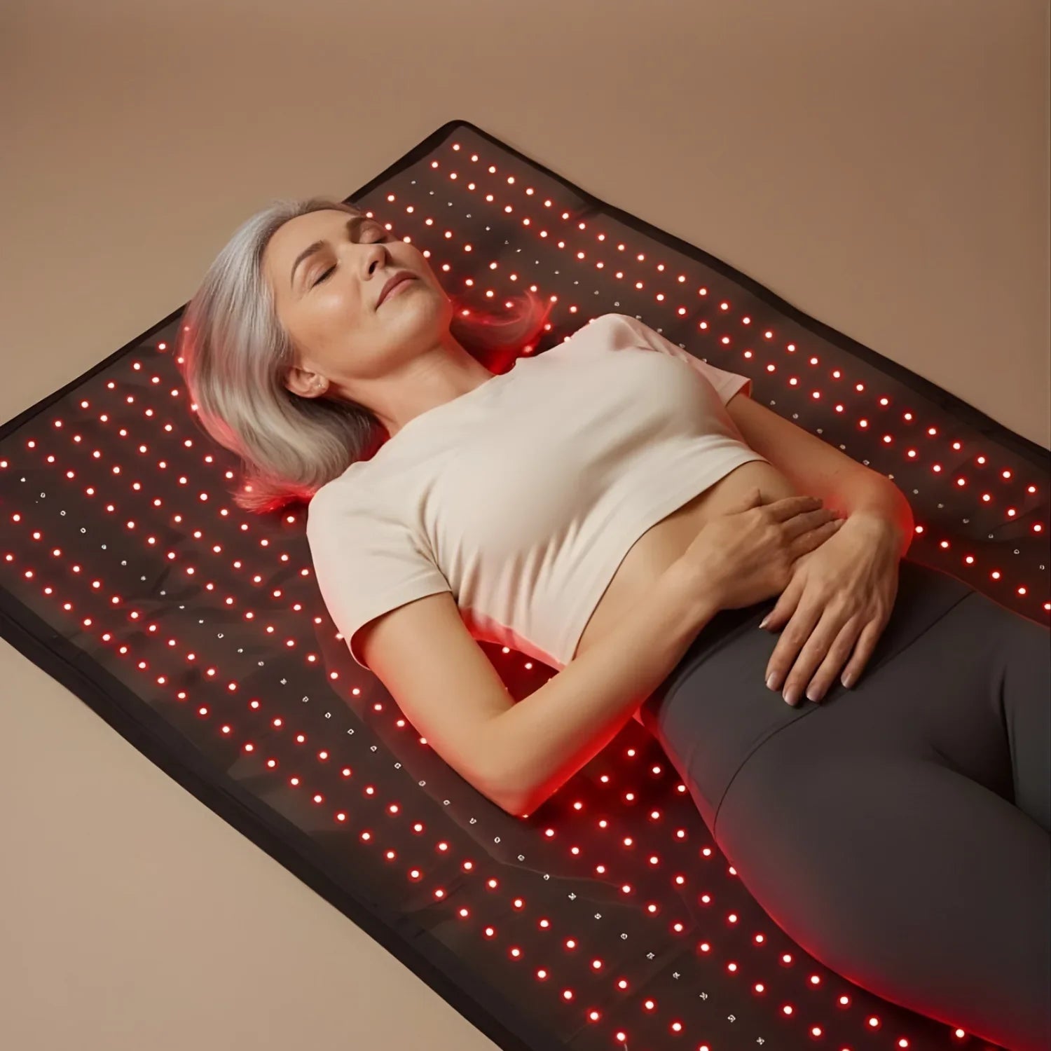 Woman relaxing on the Nicebeam Full Body Red Light Therapy Mat, enjoying red light therapy for skin rejuvenation.