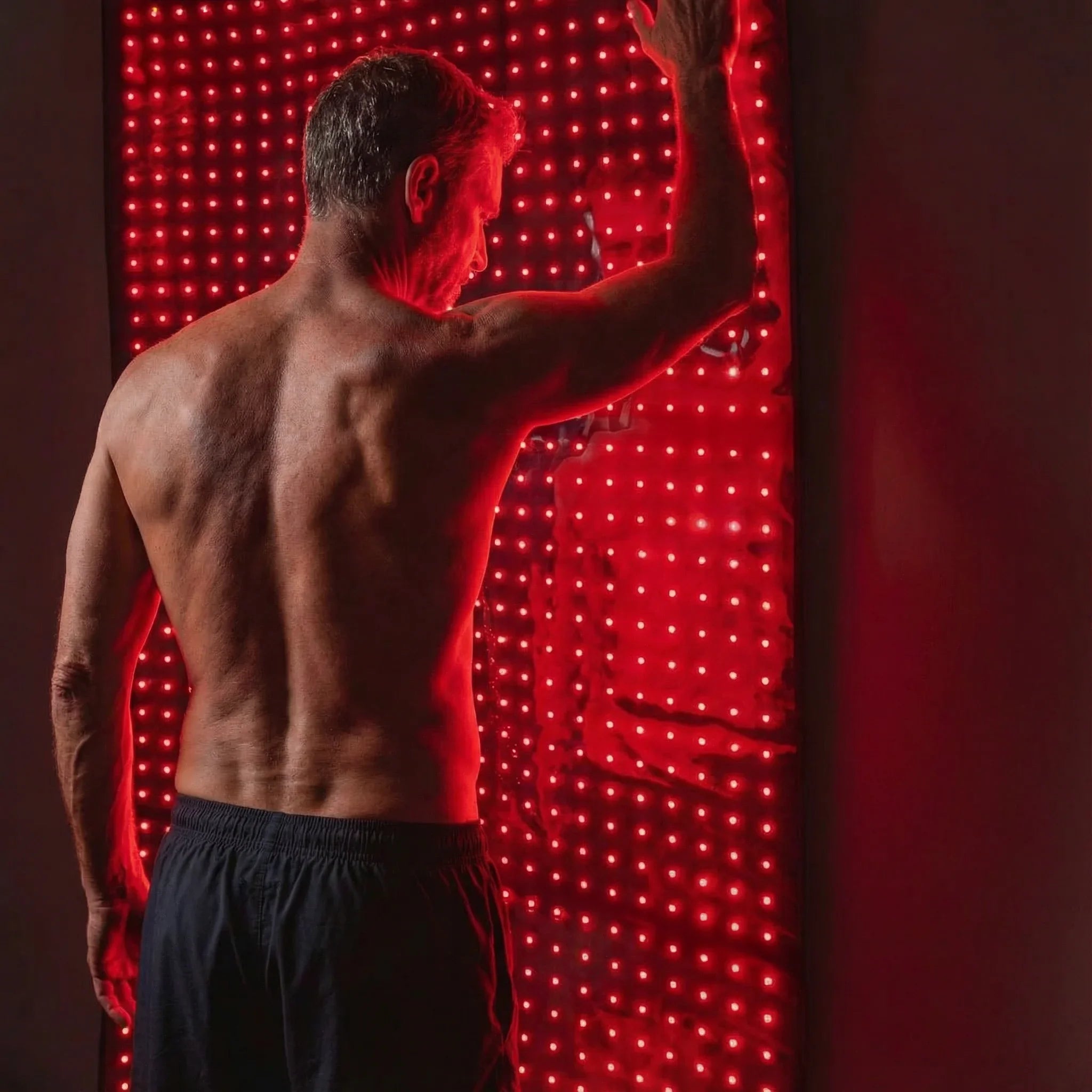 Man using Nicebeam Full Body Red Light Therapy Mat for skin rejuvenation and wellness.